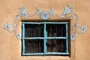 Ornate Window - turquoise painted window mounted in an adobe style building Ornate Window - turquoise painted window mounted in an adobe style building