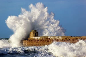Power Collection: Portreath - wave breaks over pier in storm - Cornwall - UK
