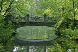 Romantic bridge - in baroque style reflecting in brook in spring forest Romantic bridge - in baroque style reflecting in brook in spring forest