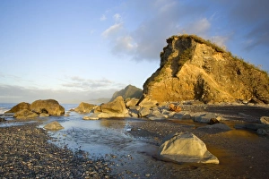 Shoreline - cliffs and rocks at Gillespies Beach in last evening light Shoreline - cliffs and rocks at Gillespies Beach in last evening light