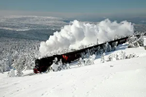 Small Gauge Steam Locomotive - riding through snow covered winter landscape Small Gauge Steam Locomotive - riding through snow covered winter landscape