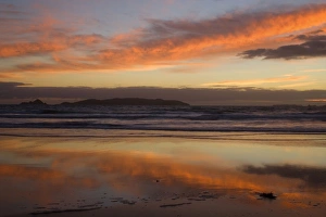Sunrise - spectacular sunrise over the ocean with clouds blazing in all hues of yellow Sunrise - spectacular sunrise over the ocean with clouds blazing in all hues of yellow