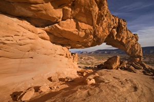 Sunset Arch - beautiful rock arch framing Navajo Mountain in the background Sunset Arch - beautiful rock arch framing Navajo Mountain in the background