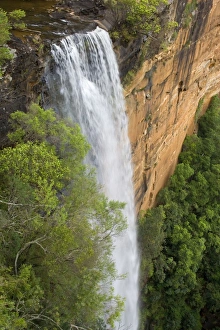 Tianjara Falls - view of stunning waterfall rushing over a red cliff from above Tianjara Falls - view of stunning waterfall rushing over a red cliff from above
