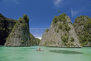 Tourists kayaking in bay, Misool Island