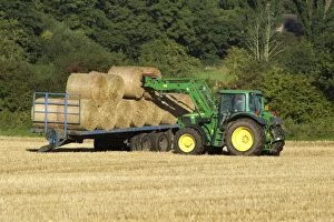 Baler Gallery: Tractor carrying bales of hay and loading onto