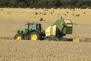 Baler Gallery: Tractor pulling straw baling machine in field