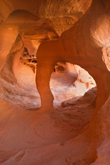 Windstone - erosion sculpted arch inside a cave-like alcove of bright red sandstone Windstone - erosion sculpted arch inside a cave-like alcove of bright red sandstone