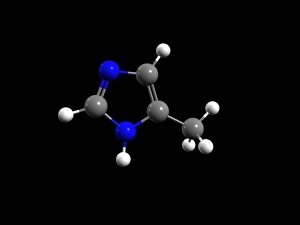 4-Methylimidazole molecule. Computer model showing the structure of a molecule of the heterocyclic organic chemical compound 4-Methylimidazole (4-MEI). Atoms are colour-coded: carbon (grey), nitrogen (blue) and hydrogen (white). 4-MEI may be formed in the browning of certain foods. There has been concern about the its presence in caramel colour (the most used food and beverage colouring). At very high doses (360 mg/kg of body weight) it has been shown to have adverse effects in some animals. However, other studies have shown no ill effects in other animals. In January 2011 California, USA, added 4-MEI to its list of probable carcinogens and stipulated 16 micrograms per day as the No Significant Risk Level intake. This level is considerably less than 4-Methylimidazole molecule C013 / 9438