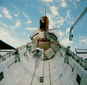 Astronaut van Hoften in Shuttle cargo bay, 41-C