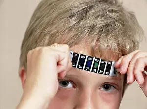 Images Dated 4th June 2003: Boy measuring his temperature