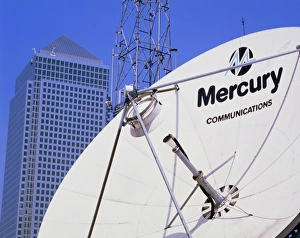 Communications dish, with Canary Wharf in b/ground Communications dish, with Canary Wharf in b/ground