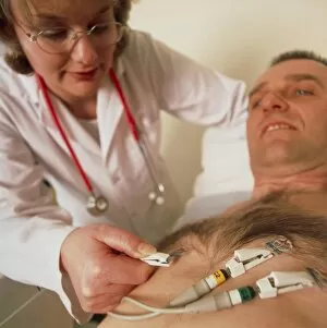 Images Dated 8th November 2004: Doctor puts electrodes on mans chest for ECG test