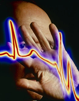 Heart disease: hand held up to irregular ECG trace Heart disease: hand held up to irregular ECG trace