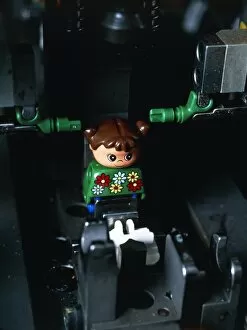 Images Dated 6th December 1999: Lego doll in an assembly machine