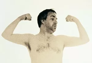 Images Dated 23rd October 2002: Man showing off his arm muscles