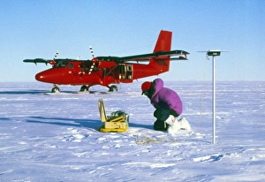 Researcher measures the flow rate of a glacier Researcher measures the flow rate of a glacier