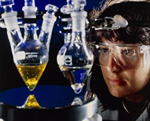Researcher monitoring catalyst experiment Researcher monitoring catalyst experiment