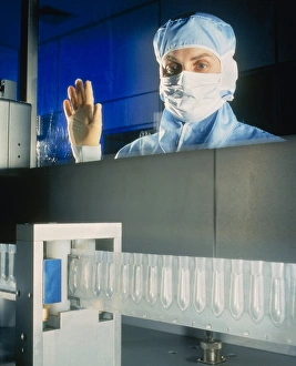 Technician monitoring suppository drug production Technician monitoring suppository drug production