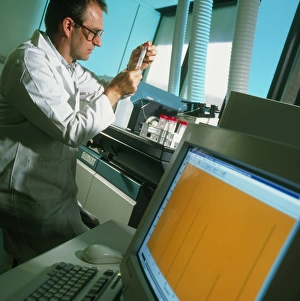Technician prepares samples for mass spectrometer Technician prepares samples for mass spectrometer