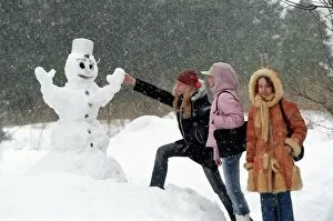 Activities Gallery: Teenage girls with a snowman