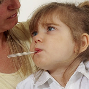 Young girl with fever has oral temperature taken Young girl with fever has oral temperature taken