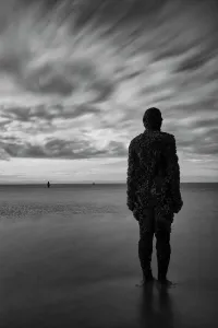 Prints of England, Merseyside, Antony Gormley Another Place. Antony Gormley sculptures at Crosby Beach near Liverpool in England Merseyside Prints: Antony Gormley Sculpture Print