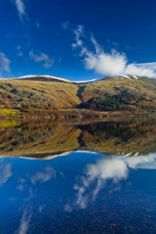 England, Cumbria, Lake District National Park. Lakeland hills reflected upon the still face of the Thirlmere
