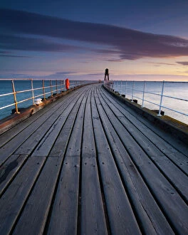 Jetty Gallery: England, North Yorkshire, Whitby. One of the entrance piers of Whitby Harbour at dawn