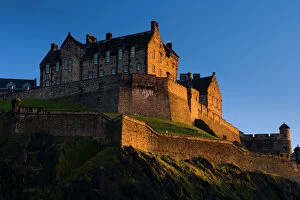 Tourist Attraction Collection: Scotland, Edinburgh, Edinburgh Castle. The last light of the setting sun illuminates Edinburgh