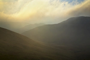 Scotland, Scottish Borders, The Pennine Way. Mist begins to shroud the rolling hills Scotland, Scottish Borders, The Pennine Way. Mist begins to shroud the rolling hills
