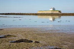 Images Dated 6th October 2007: The 12th century Llangwyfan church on small tidal island reflected in calm sea