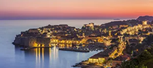 Aerial panorama of Dubrovnik Old Town at night with orange sunset sky, UNESCO World Heritage Site Aerial panorama of Dubrovnik Old Town at night with orange sunset sky, UNESCO World Heritage Site