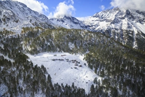 Aerial view of the alpine village of Laguzzola framed by woods and snowy peaks, Spluga Valley Aerial view of the alpine village of Laguzzola framed by woods and snowy peaks, Spluga Valley