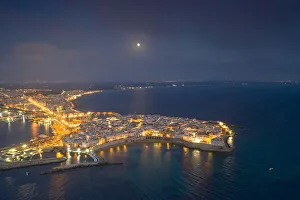 Aerial view of the coastal town of Gallipoli illuminated at night, Lecce province Aerial view of the coastal town of Gallipoli illuminated at night, Lecce province