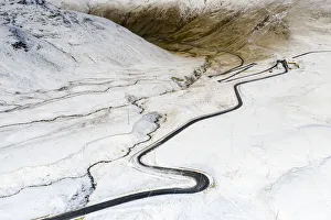 Aerial view by drone of S-shape road towards Stelvio Pass in the snowy landscape, Bormio Aerial view by drone of S-shape road towards Stelvio Pass in the snowy landscape, Bormio