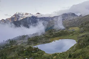 Aerial view of Hopschusee lake with Fletschhorn and Galehorn peaks in mist at sunrise Aerial view of Hopschusee lake with Fletschhorn and Galehorn peaks in mist at sunrise