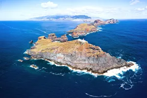 Aerial view of lighthouse on cliffs in the blue Atlantic Ocean, Sao Lourenco Peninsula Aerial view of lighthouse on cliffs in the blue Atlantic Ocean, Sao Lourenco Peninsula