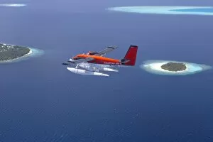 Maldives Gallery: Aerial view of Maldivian air taxi flying above islands in the Maldives