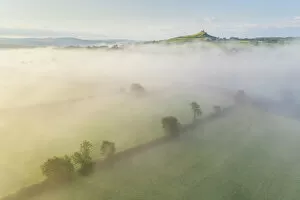 Paddock Gallery: Aerial view over mist shrouded countryside towards Brentor Church, Dartmoor National Park, Devon