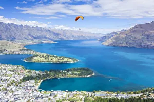 Aerial view of Queenstown, paraglider, Lake Wakatipu and The Remarkables mountains Aerial view of Queenstown, paraglider, Lake Wakatipu and The Remarkables mountains