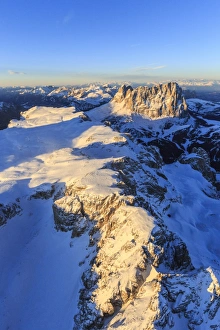 Aerial view of Sassolungo and Grohmann peaks at sunset, Sella Group, Dolomites, Trentino-Alto Adige Aerial view of Sassolungo and Grohmann peaks at sunset, Sella Group, Dolomites, Trentino-Alto Adige