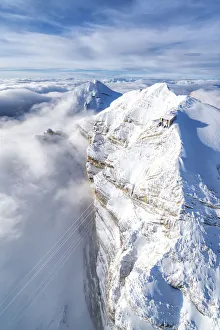 Aerial view of snow capped Tofane group and scenic Freccia nel Cielo cableway, Dolomites Aerial view of snow capped Tofane group and scenic Freccia nel Cielo cableway, Dolomites