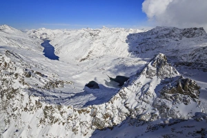 Aerial view of snowy Peak Peloso surrounded by Lago di Lei, Val di Lei Chiavenna Aerial view of snowy Peak Peloso surrounded by Lago di Lei, Val di Lei Chiavenna