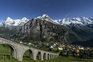 Alpine village of Murren and funicular railway lit by star trail, Lauterbrunnen Alpine village of Murren and funicular railway lit by star trail, Lauterbrunnen