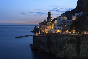 Amalfi coast road light trails from cars with Church of Santa Maria Maddalena at blue hour Amalfi coast road light trails from cars with Church of Santa Maria Maddalena at blue hour