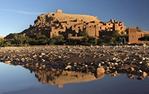 The ancient Kasbah Ait Benhaddou bathed in morning light and reflecting in river The ancient Kasbah Ait Benhaddou bathed in morning light and reflecting in river