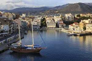Attractive harbour and town backed by mountains, from Mirabello Bay, Agios Nikolaos Attractive harbour and town backed by mountains, from Mirabello Bay, Agios Nikolaos