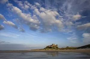 Images Dated 26th April 2009: Bamburgh Castle bathed in evening light, viewed from Bamburgh Beach, Bamburgh