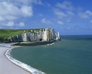 Beach, cliffs and rock arch, known as the Falaises, on the coast near Etretat Beach, cliffs and rock arch, known as the Falaises, on the coast near Etretat
